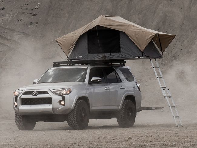 Load image into Gallery viewer, Toyota 4Runner with Front Runner Slimline II Roof Rack and mounted rooftop tent in an off-road setting
