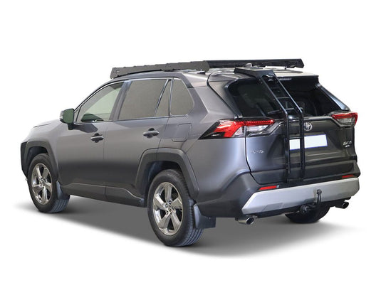 Alt text: "Gray 2019 Toyota RAV4 equipped with a Front Runner ladder attached to the rear door, isolated on a white background."