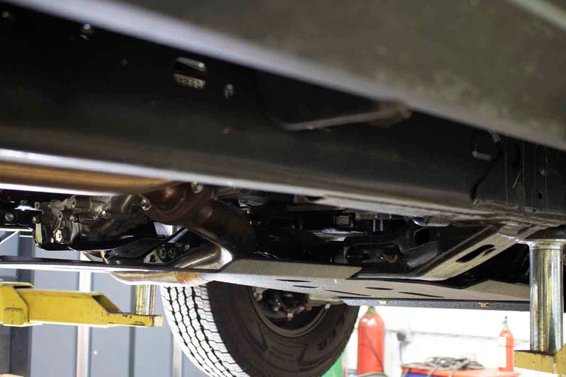 Load image into Gallery viewer, &quot;Fishbone Offroad Skid Plates installed on 2016 Current Toyota Tacoma underside view on lift&quot;
