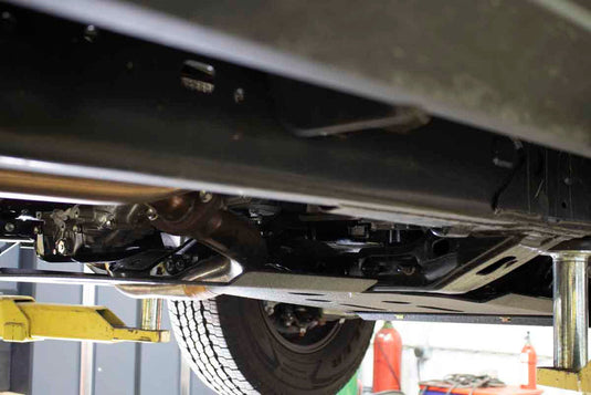 "Fishbone Offroad Skid Plates installed on 2016 Current Toyota Tacoma underside view on lift"