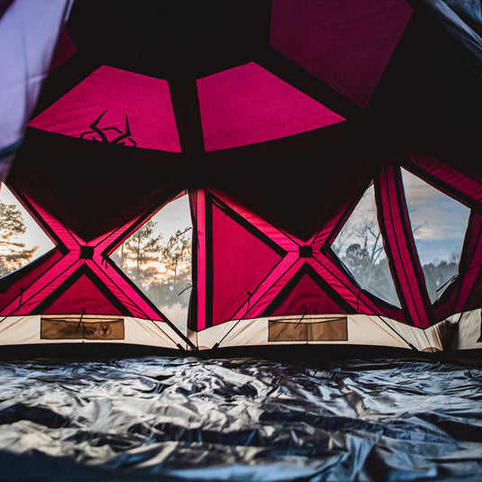 Interior view of Gazelle Tents T-Hex Hub Tent Overland Edition with open windows during sunset.