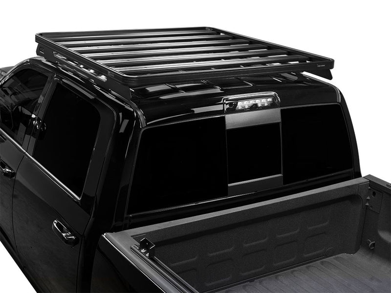 Load image into Gallery viewer, Front Runner Slimline II Roof Rack Kit installed on a black RAM 1500/2500/3500 Crew Cab, model year 2009-present, viewed from the rear angle.
