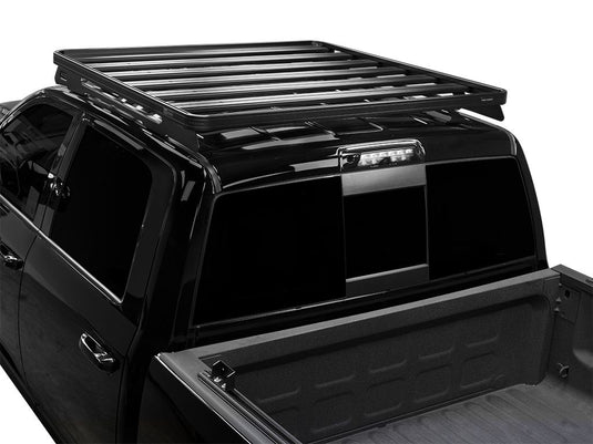 Front Runner Slimline II Roof Rack Kit installed on a black RAM 1500/2500/3500 Crew Cab, model year 2009-present, viewed from the rear angle.