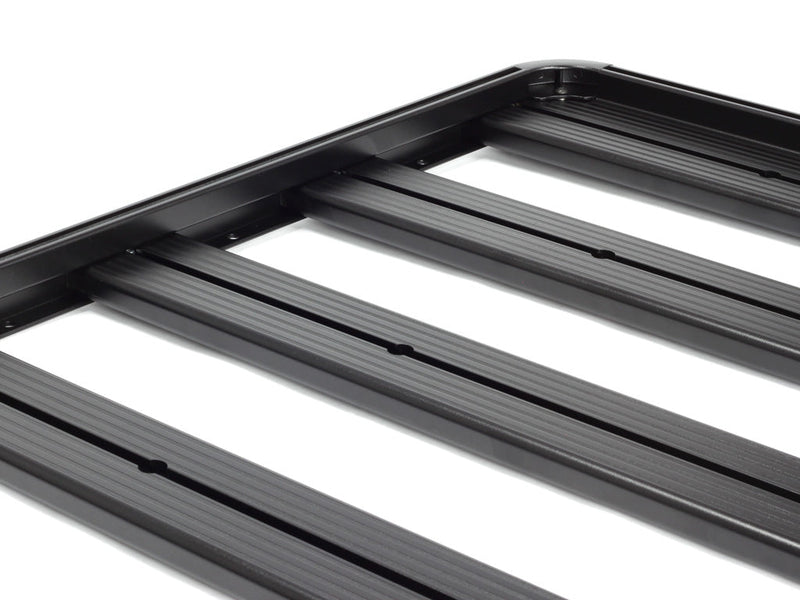 Load image into Gallery viewer, Close-up view of the Front Runner Slimline II half roof rack kit for Mercedes Benz Sprinter 2006-current model showing the durable black metal bars and frame construction.
