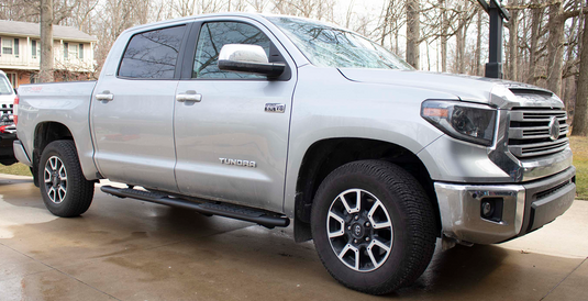 Alt text: "Silver Toyota Tundra Double Cab showcasing Fishbone Offroad 5 Inch Oval Side Steps installed for easy access"