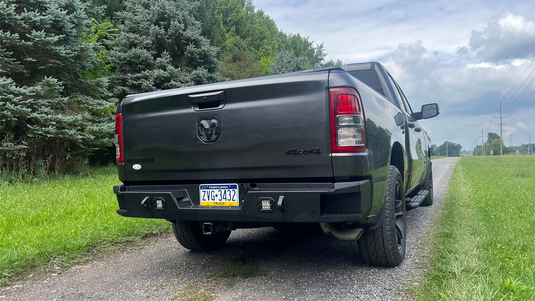 2019-2023 Ram 1500 equipped with Fishbone Offroad Pike Rear Bumper, showcased outdoors.