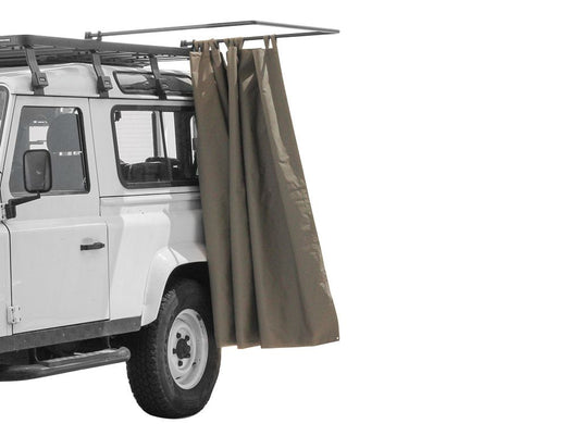 Front Runner Rack Mount Shower Cubicle attached to a white off-road vehicle for outdoor camping convenience.