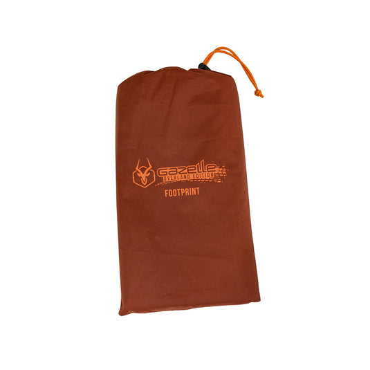 Alt text: "Gazelle Tents T3X Tent Footprint in storage bag with logo on brown fabric."
