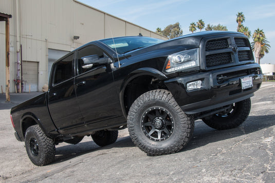 Black pickup truck equipped with ICON Vehicle Dynamics Rebound HD alloy wheels in satin black finish.