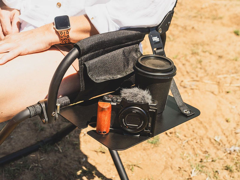 Load image into Gallery viewer, &quot;Front Runner Expander Chair with attached Side Table holding a camera, travel mug, and personal accessories outdoors&quot;
