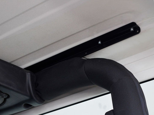 Installation detail of Front Runner Extreme Roof Rack Kit on Jeep Wrangler JK 2 Door, showing the bracket attachment to vehicle roof.