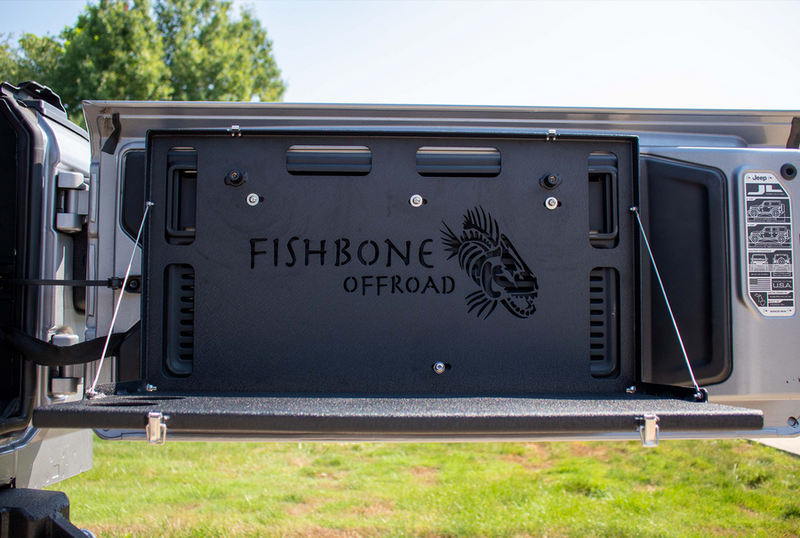 Load image into Gallery viewer, Alt text: &quot;Fishbone Offroad tailgate table installed on a Jeep, compatible with JK, JKU, JL, JLU Wrangler and Ford Bronco models.&quot;
