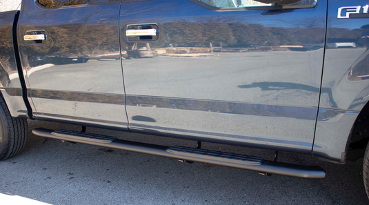 Alt text: "Fishbone Offroad 5-inch Oval Side Steps installed on 2015-2023 Ford F-Series Super Cab truck, side view."