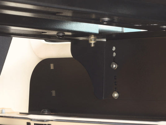 Close-up view of the Front Runner Jeep Wrangler JKU 4-Door Cargo Storage Interior Rack installed, showcasing the sturdy metal construction and bolted attachment points.