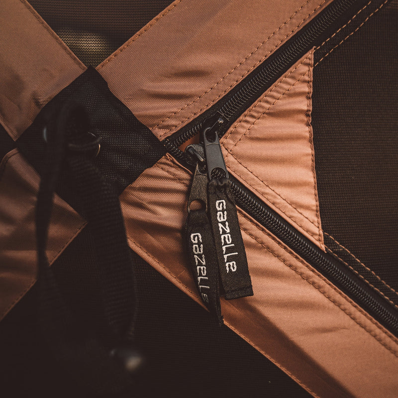 Load image into Gallery viewer, Close-up of Gazelle Tents G6 Deluxe 6-Sided Portable Gazebo zipper and logo detail
