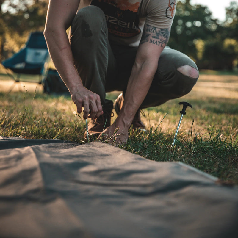 Load image into Gallery viewer, Person setting up a Gazelle Tents T4 Hub Tent Overland Edition at a campsite with another tent in the background.
