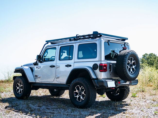 Load image into Gallery viewer, Silver 2018 Jeep Wrangler JL 4-Door equipped with Extreme Slimline II Roof Rack Kit by Front Runner parked outdoors.
