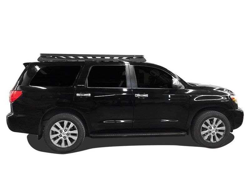 Load image into Gallery viewer, Black 2008 Toyota Sequoia equipped with Front Runner Slimline II Roof Rack Kit, side profile view.
