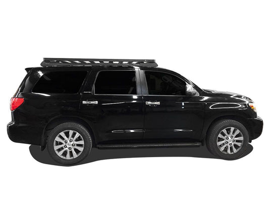 Black 2008 Toyota Sequoia equipped with Front Runner Slimline II Roof Rack Kit, side profile view.