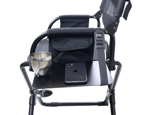 Alt text: "Front Runner Expander Chair with side table showcasing a metal mug and smartphone, emphasizing portable outdoor comfort and convenience."