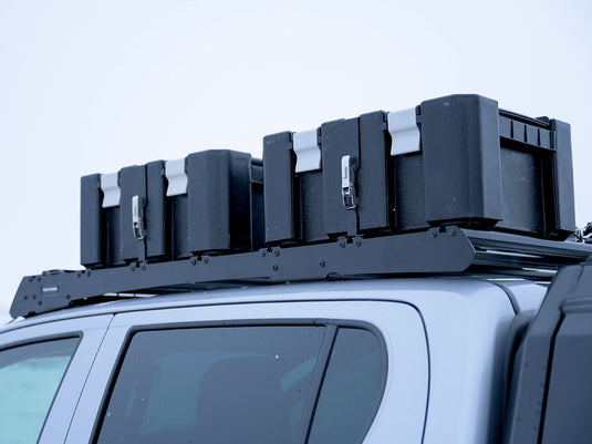 Front Runner Wolf Pack Pro storage boxes securely mounted on vehicle roof rack with durable brackets