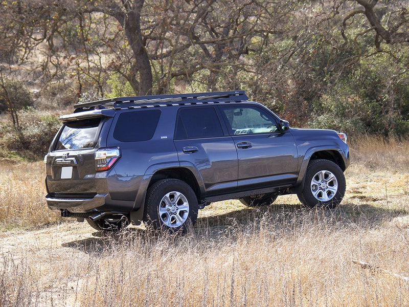 Load image into Gallery viewer, Gray Toyota 4Runner equipped with Front Runner Slimline II Roof Rack in outdoor setting
