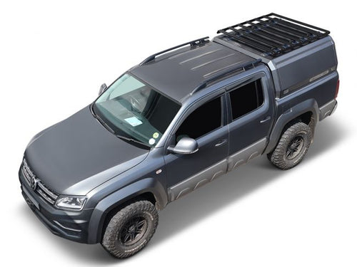 alt=inchDark gray pickup truck equipped with Front Runner Slimsport Rack Kit on load bed canopy, viewed from an angled top-down perspectiveinch
