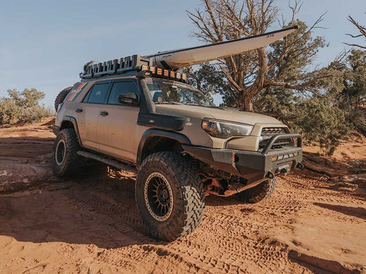 Toyota 4Runner equipped with Front Runner Slimline II Roof Rack Kit on rugged terrain, showcasing the durable vehicle modification for outdoor and off-road enthusiasts.