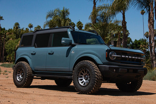 Ford Bronco equipped with ICON Vehicle Dynamics Compression wheels in Titanium finish parked outdoors
