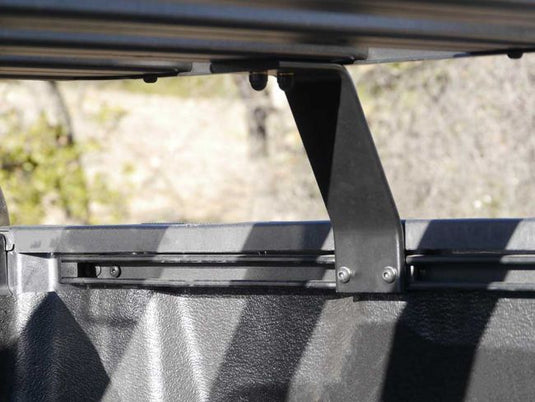 Close-up of Front Runner Slimline II Load Bed Rack mounting bracket on a Toyota Tundra Crewmax 5.5' bed.
